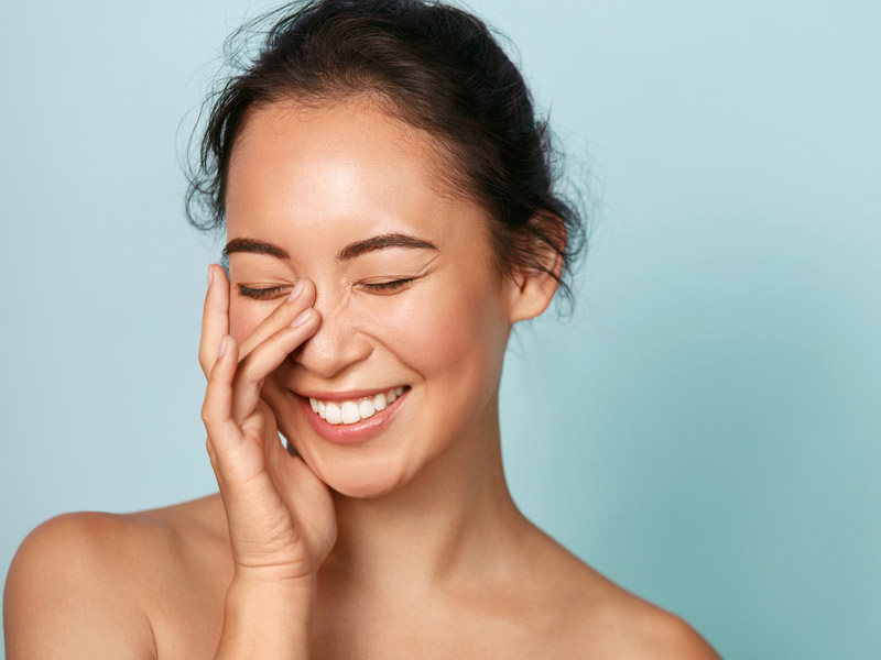 beautiful woman touching her face