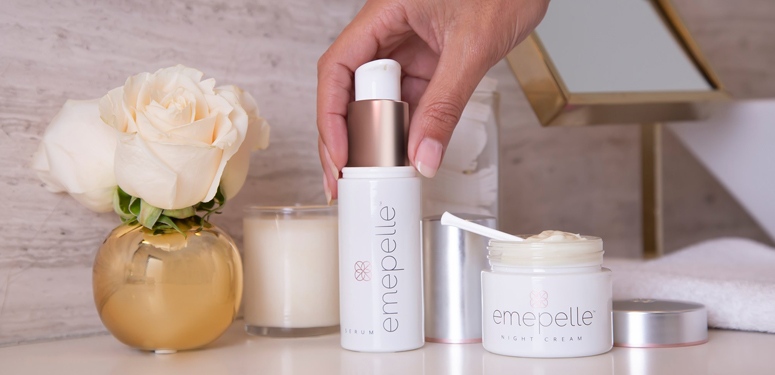 Woman holds Remote Emepelle Skincare Line cream for estrogen-deficient skin in Dallas, Texas