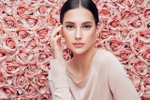 A woman posing with hand on her temple at EpiCentre Skin Care & Laser Center