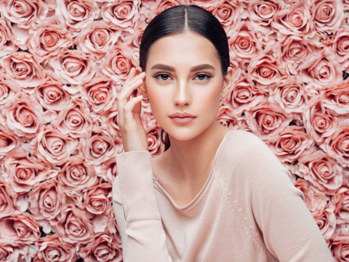 A woman posing with hand on her temple at EpiCentre Skin Care & Laser Center